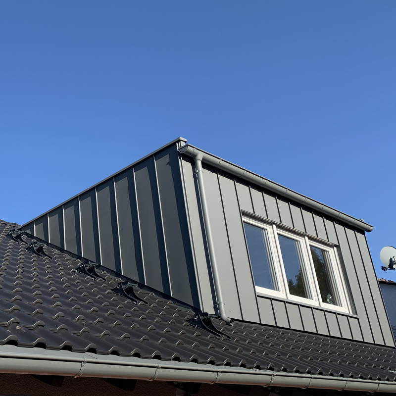Ein neues Dach mit einem schönen modernen Ausbau, der mit Zink in Doppelstehfalztechnik verkleidet ist.